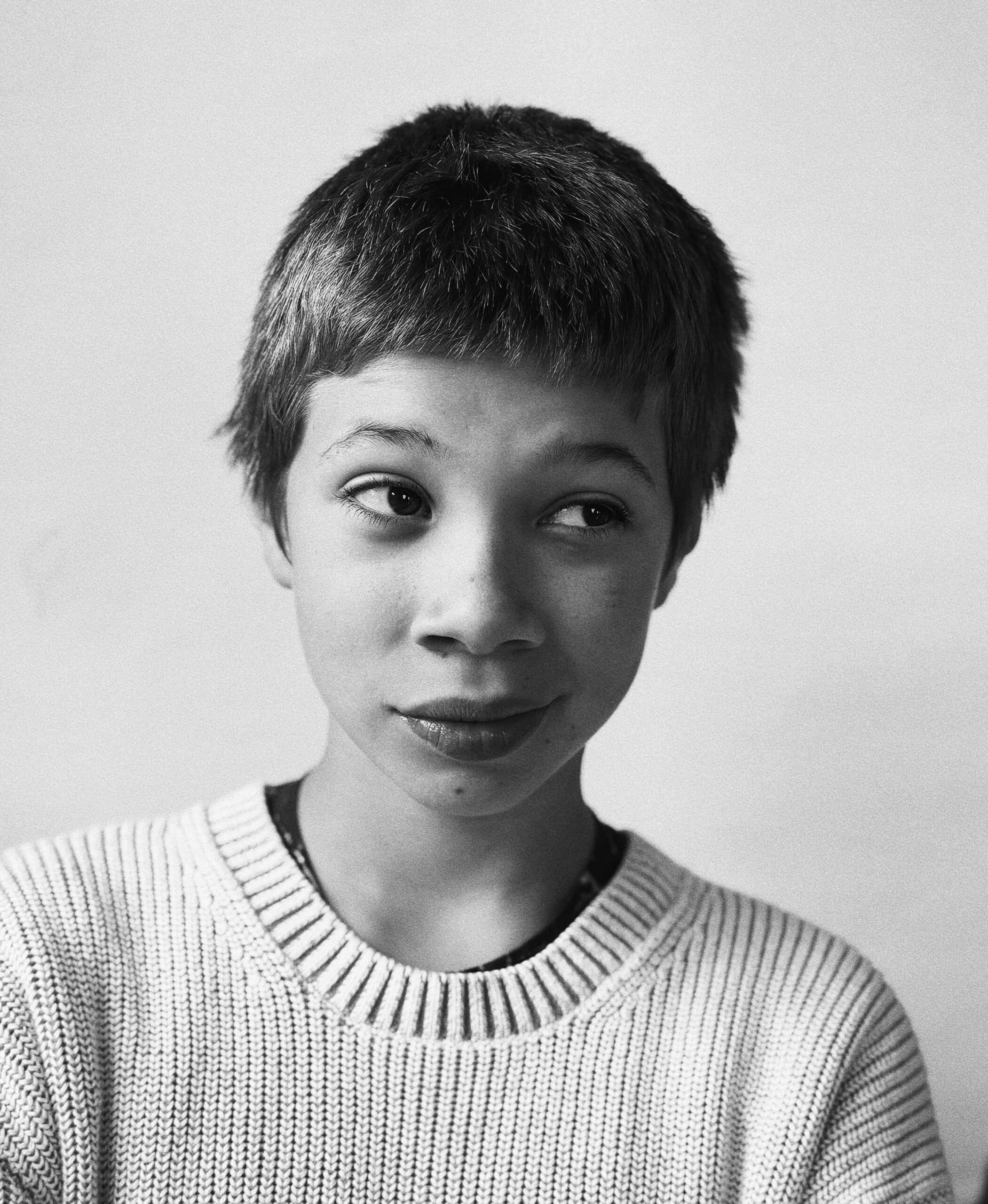 Black-and-white portrait of a child in a knit sweater looking to the side. Redwood Literacy overview for parents whose child was just diagnosed with dyslexia, dysgraphia, or dyscalculia