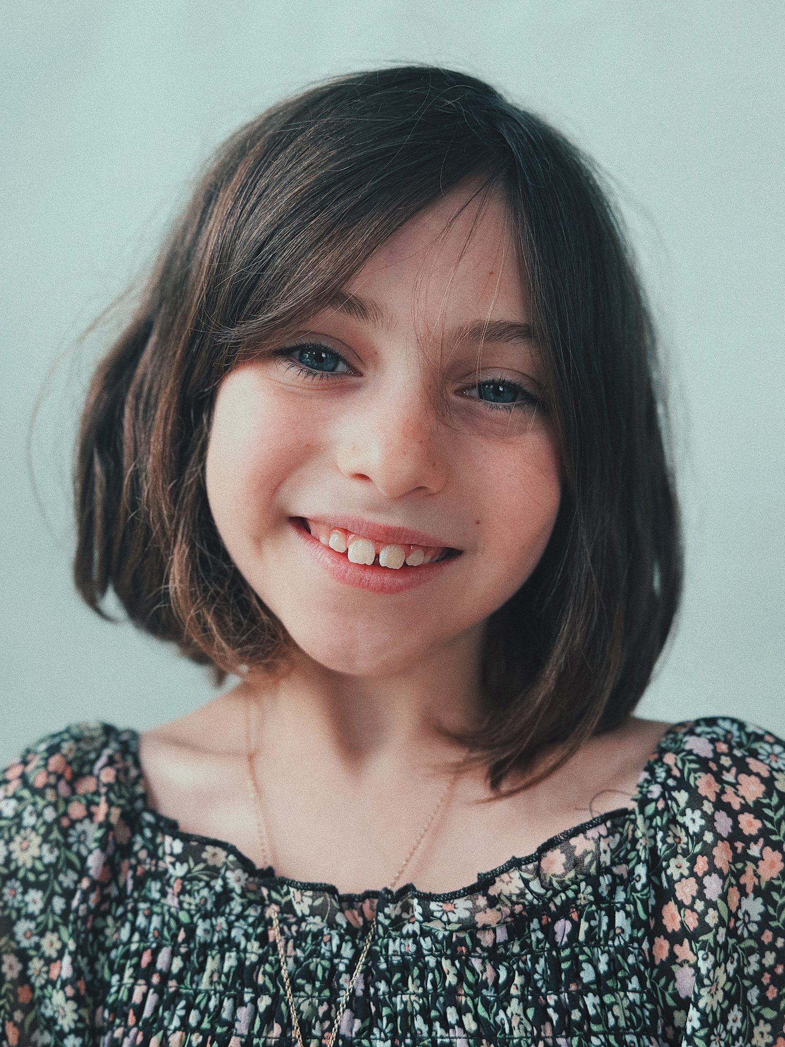 Redwood Literacy dyslexia tutoring student in Nashville, bright smile, bob haircut, floral top