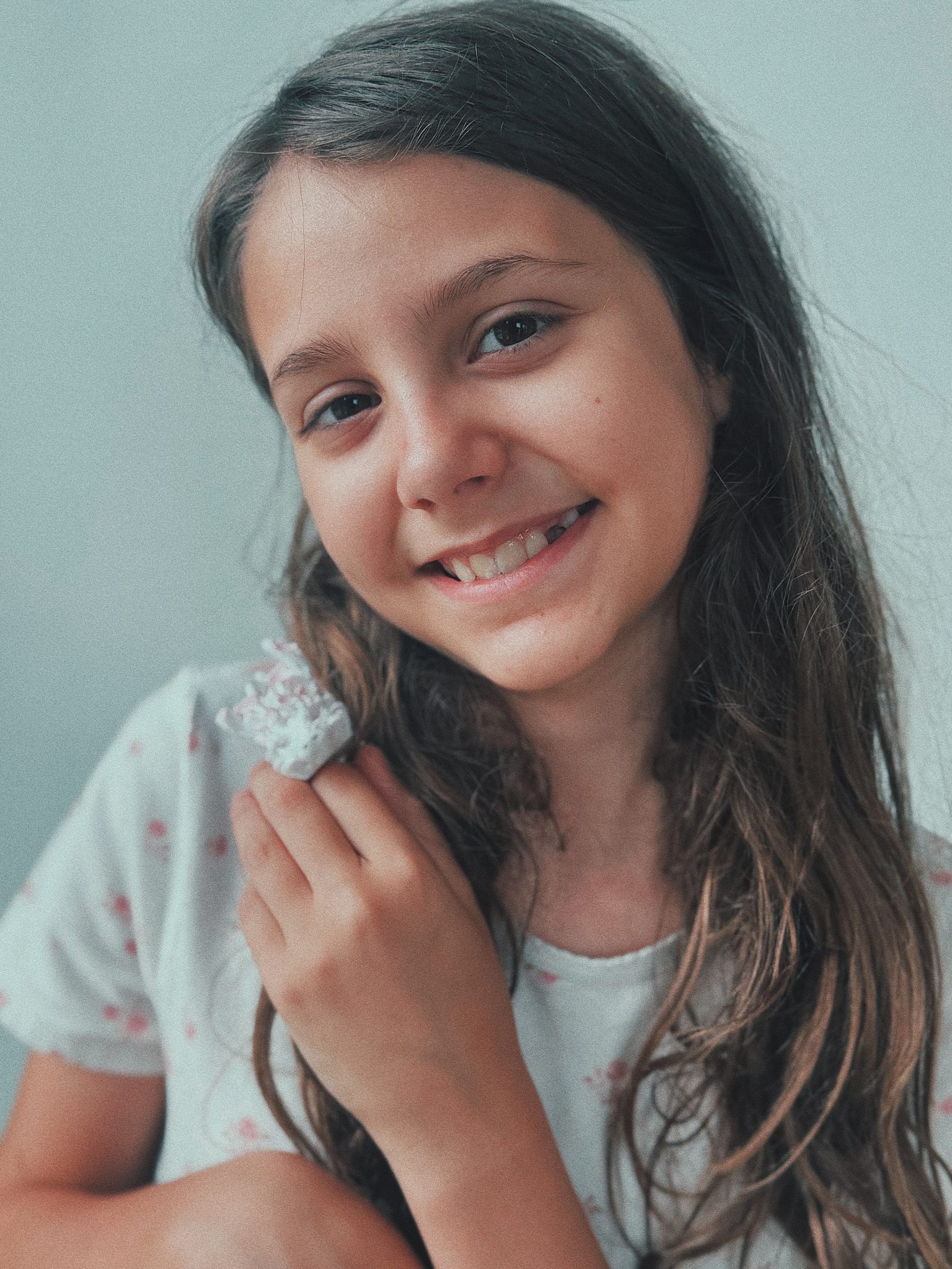 Redwood Literacy dyslexia tutoring student in Nashville, smiling while holding a seashell
